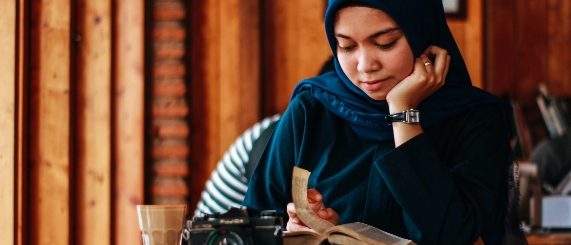 Muslim woman reading a book